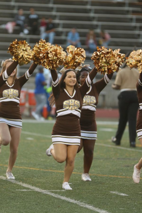 The CHHS cheerleaders show their school pride while supporting other athletes at a home football game.