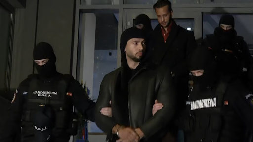 Andrew Tate (center) and his brother Tristan are taken into custody in Bucharest