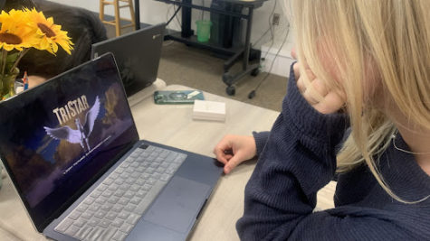student watches a movie in class