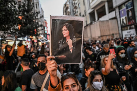 Protester Holds up Picture of Mahsa Amini