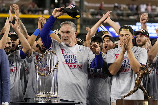 Texas Rangers manager Bruce Bochy celebrates with the trophy after winning Game 5 of the baseball World Series against the Arizona Diamondbacks Wednesday, Nov. 1, 2023, in Phoenix. The Rangers won 5-0 to win the series 4-1. 