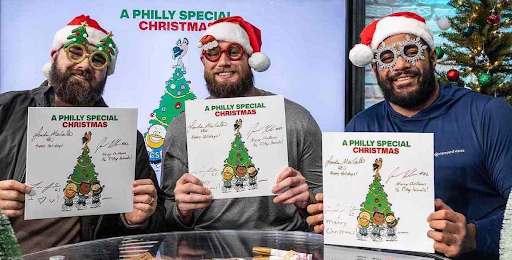 Eagles offensive linemen Jason Kelce, Lane Johnson, Jordan Mailata (left to right) with their Charlie Brown style Christmas album cover
