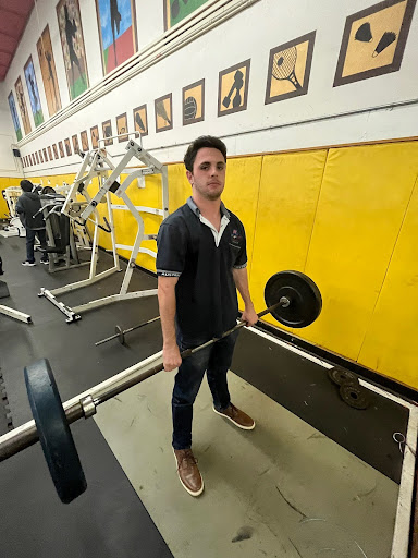 Jason Heller, Treasurer of the Weightlifting Club, lifting weights after school during a club meeting. 