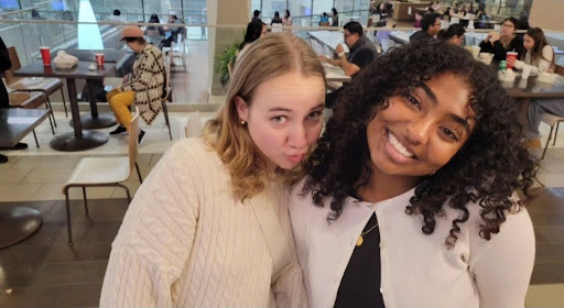 Seniors Emily Haynes and Claire Richie smile in anticipation of their Valentine's Day plans. They plan to have a group cafe lunch in all pink, and they are so excited they can barely hold it in. (Nyala Levvi)
