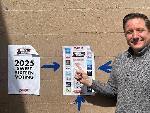 (Mr. Pedersen posing next to the posters he made for the March Madness Competition. Cheerful to experience another year of presentation and school-wide voting. 