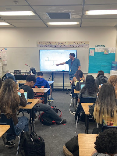 Mr. Adams teaches his period 5 students by guiding them through their assignment they’re about to complete. (Victoria Ochoa) 
